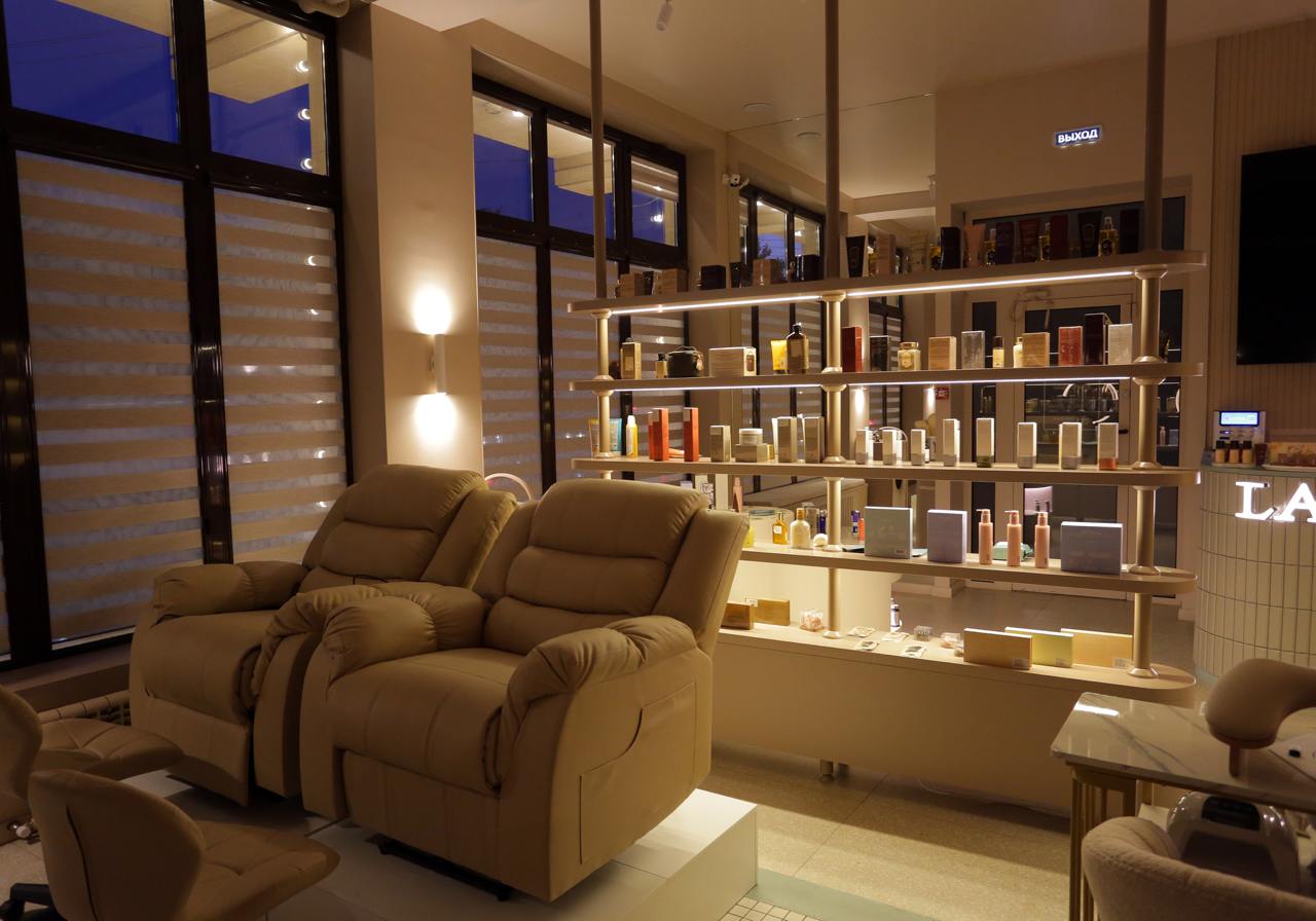 Daylight view of LALIQ salon with reclining chairs and product shelves
